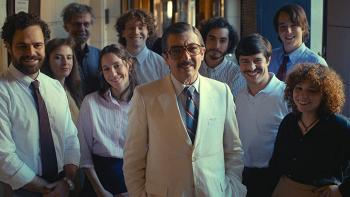 Argentina, 1985: A middle-aged man poses for a photograph with his legal team of young people