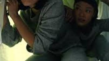 Arini by Love.inc: Facing forward, 2 Indonesian woman in grey pajamas crouch their way under a table