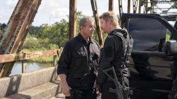 Armor Movie: On the bridge, near a black truck, Rook (Sylvester Stallone) and Smoke (Dash Mihok) have a tense discussion