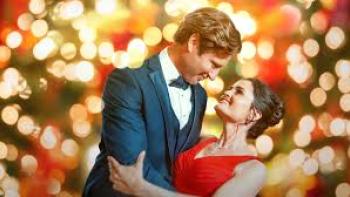 A Royal Date for Christmas: Damon Runyan and Danica McKellar embrace by Christmas tree