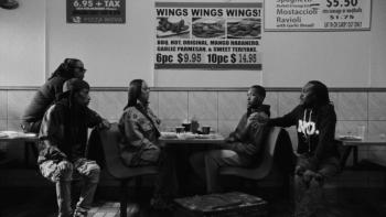 As We Speak: Rap Music on Trial movie: In a diner with food posters on the wall, 5 Black men and women sit talking