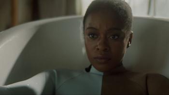 Assassin Movie: Alexa, wearing some kind of special brown and white suit, sits in a bathtub, ready for an experiment