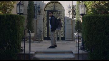 At the Gates Movie: As his mother knocks on the door of the wealthy estate where she works, a Latino teen looks toward the gated entry