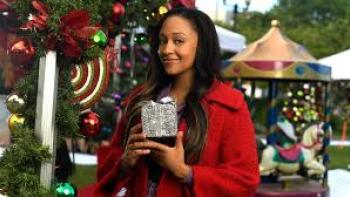 A Very Vintage Christmas: Tia Mowry holds a small gift