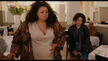Babes Movie: Pregnant Michelle Buteau is unhappy as she stands in a restaurant, Ilana Glazer behind her