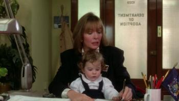 Baby Boom: Diane Keaton sits with a baby on her knee in an adoption office.
