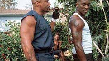 Baby Boy: Two Black men in tank tops walk outside