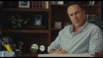 Bad Counselors movie: Chris Klein sits at a desk with his hands folded together