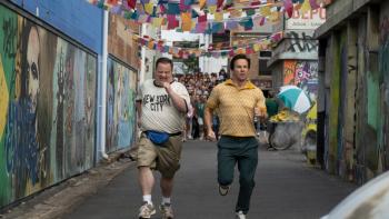 Balls Up: Paul Walter Hauser and Mark Wahlberg run away.