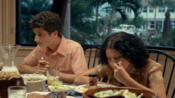 Bart Got a Room: A teenage boy and girl eating a meal at a dining table, with a window view behind them