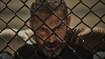 Beast Movie: During a rigorous training, an exhausted Patton James rests his head against a chain-link fence