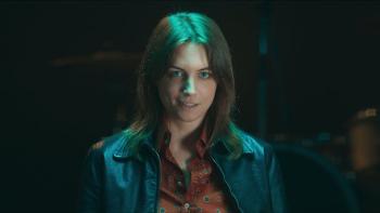 Beautiful Rebel movie: Italian white woman in black leather jacket center smiles in dark room