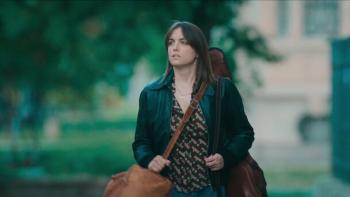 Beautiful Rebel movie: Italian white woman in black leather jacket center holds bag and guitar on back while in park