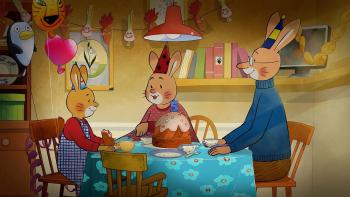 Three animated rabbits sit around a table wearing birthday hats
