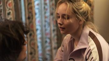 Black Dog: A young woman with blond hair looks longingly at a young man