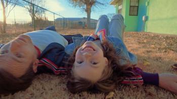 Bleeding Love Movie: A dad (Ewan McGregor) and his 6-year-old daughter lie on their backs outside on the ground