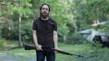 Blue Ruin: A bearded White man holding a rifle
