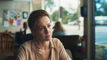 Blue Ruin: A middle-aged White woman looks sad sitting in a diner