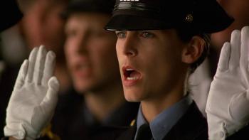 Blue Steel: Jamie Lee Curtis holds up a white-gloved hand to swear in as a newly qualified police officer