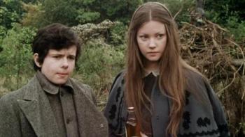 The Amazing Mr. Blunden: A young White boy and girl stand together in a garden looking serious