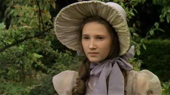 The Amazing Mr. Blunden: A young White girl stands wearing a large bonnet in a garden