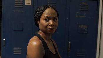 Bobcat Moretti Movie: Sheria Irving looks concerned as she stands in front of changing room lockers