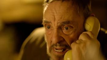 Bone Keeper: John Rhys-Davies looks worried as he speaks into a phone