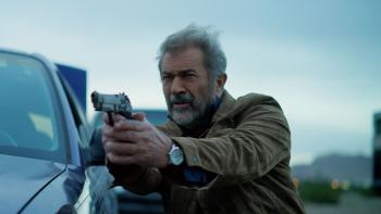 Boneyard movie: Mel Gibson points gun leaning next to car
