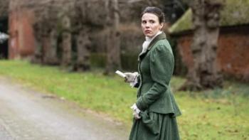 Borley Rectory — The Awakening: A White woman in 1900 clothing looks over her shoulder, concerned, as she walks through the grounds of a manor house
