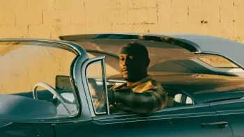 Bosco movie: Tyrese Gibson center sits in driver seat of convertible car with top down