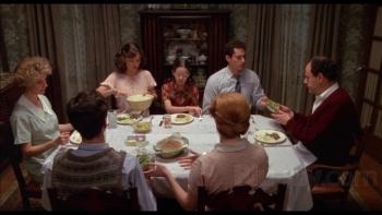 Family scene of seven people at the dinner table