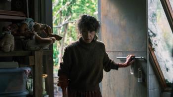 Bring Her Back Movie: An upset-looking Laura (Sally Hawkins) enters a greenhouse/storage room through a metal door
