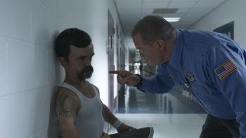 Brothers Movie: Jady (Peter Dinklage) is threatened by officer Farful (Brendan Fraser), who jabs a finger in his face