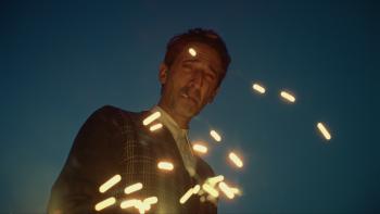 The Brutalist Movie: Architect László Tóth (Adrien Brody) smokes a cigarette as sparks fly in front of him