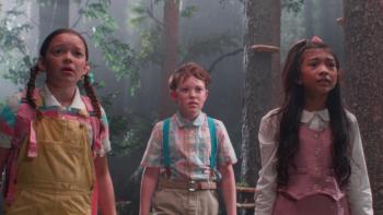 Buddy Movie: In the woods, three children dressed in pastel colors look frightened