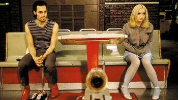 Buffalo '66: A man and woman sit on a diner bench, looking in opposite directions
