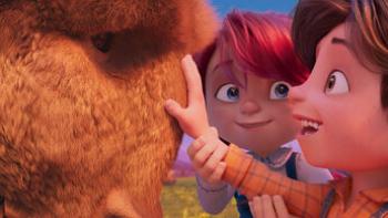 Buffalo Kids: A boy smiles as he touches a buffalo's face as a girl looks at him