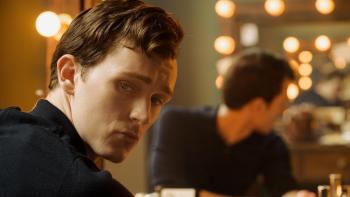 Mr. Burton: Harry Lawtey looks over his shoulder as he sits in front of a dressing room mirror