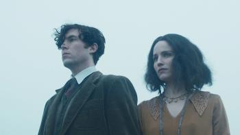 The Laureate: A young White man and woman dressed in 1920s clothes look out into the distance 