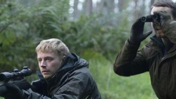 Calibre: One White man aiming a rifle and another looking through binoculars in the forest