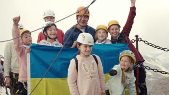 Camp Courage: Milana and others by the Ukrainian flag.