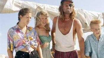 Captain Ron: Four people standing on a boat in casual summer clothing.