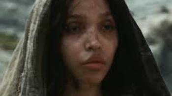 The Carpenter's Son Movie: The Mother (FKA Twigs) wears a scarf on her head and looks into the distance