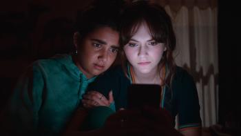 Cat Person Movie: Two female college students look at a cell phone at night with worry
