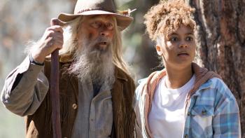 Legend of Catclaws Mountain: a man in a hat stands next to a biracial girl in the woods with shocked looks on their faces