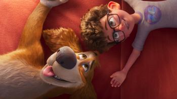 Charlie the Wonderdog movie: A tween boy with glasses and his dog lie on the ground looking at the sky 