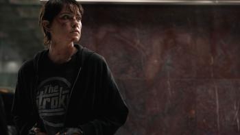 Cleaner: A bruised woman in a hoodie and gloves looks warily into the distance