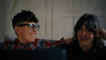 Come See Me in the Good Light movie: Andrea Gibson smiles at Megan Falley, both sitting on a couch