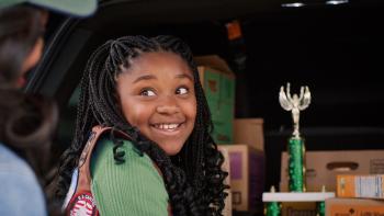 Cookie Queens movie: Nikki smiles while thinking about earning the "top seller" trophy