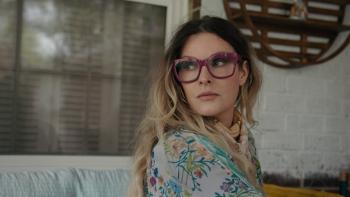 The Easy Kind movie: Singer Elizabeth Cook, with long hair and purple glasses, looks sideways in a cozy room